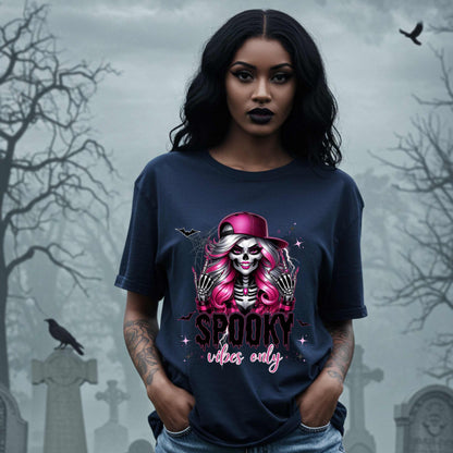  This Spooky Vibes Only tee is the perfect blend of glam and goth, featuring a pink-haired skeleton baddie with nails sharp enough to slash a pumpkin and a hat tilted like she’s haunting the runway. This shirt is for the ghouls who don’t do basic. 