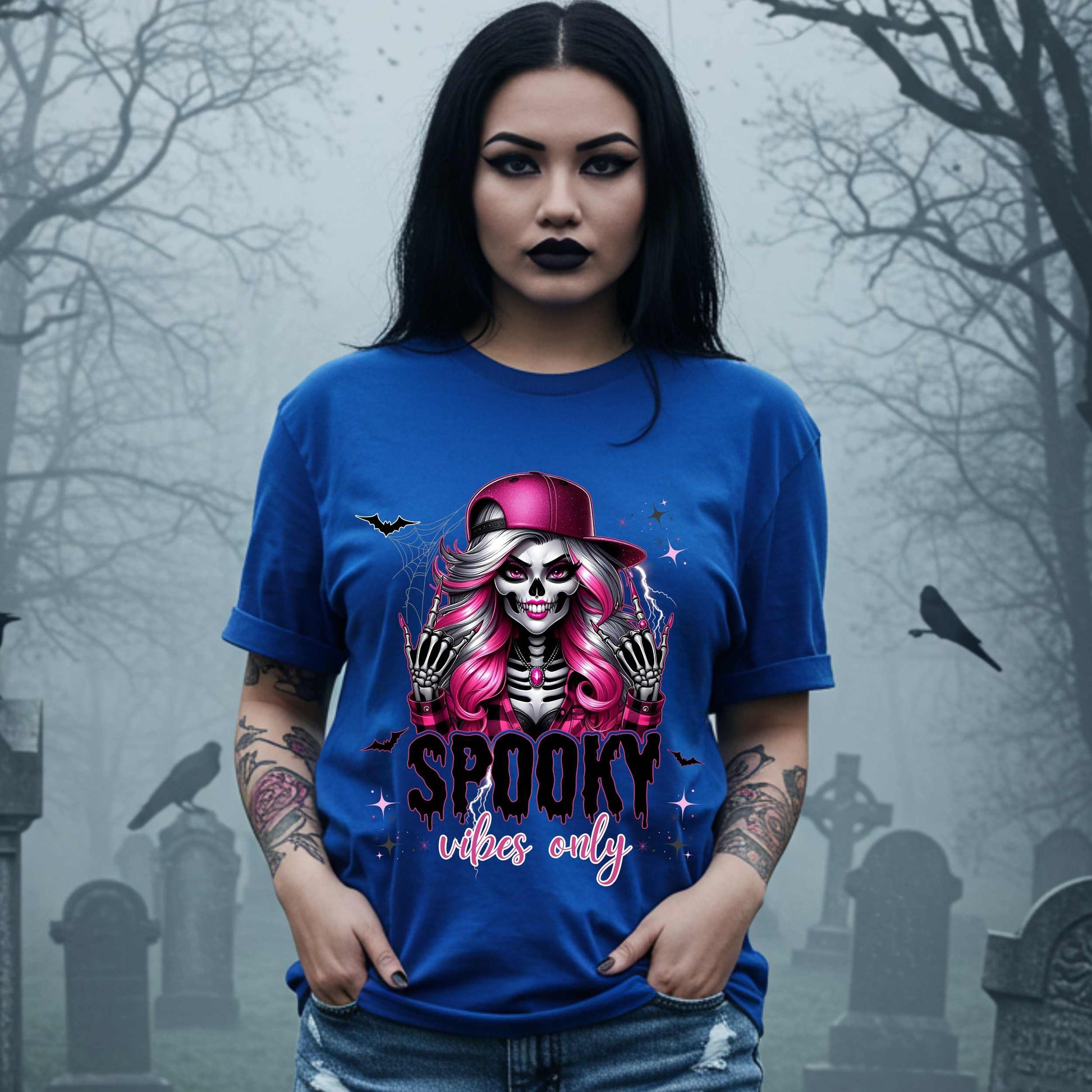  This Spooky Vibes Only tee is the perfect blend of glam and goth, featuring a pink-haired skeleton baddie with nails sharp enough to slash a pumpkin and a hat tilted like she’s haunting the runway. This shirt is for the ghouls who don’t do basic. 