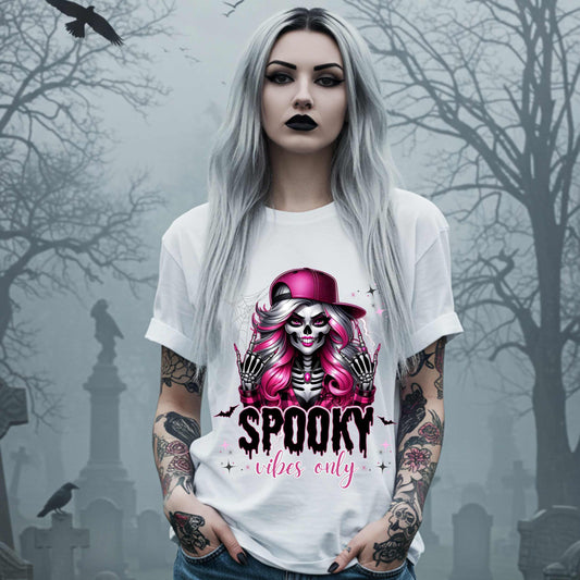  This Spooky Vibes Only tee is the perfect blend of glam and goth, featuring a pink-haired skeleton baddie with nails sharp enough to slash a pumpkin and a hat tilted like she’s haunting the runway. This shirt is for the ghouls who don’t do basic. 