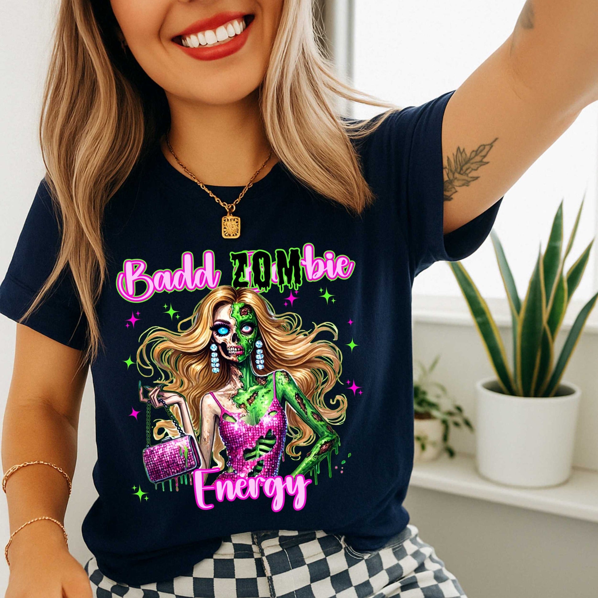 Brains, but make it fashion. This Badd Zombie Energy tee is for the girls who slay… even in the afterlife. Rocking a glittery pink dress, designer handbag, and enough undead glam to raise the dead, this zombie babe is dripping in sass (and maybe a little ooze).