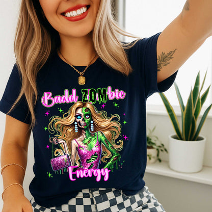 Brains, but make it fashion. This Badd Zombie Energy tee is for the girls who slay… even in the afterlife. Rocking a glittery pink dress, designer handbag, and enough undead glam to raise the dead, this zombie babe is dripping in sass (and maybe a little ooze).