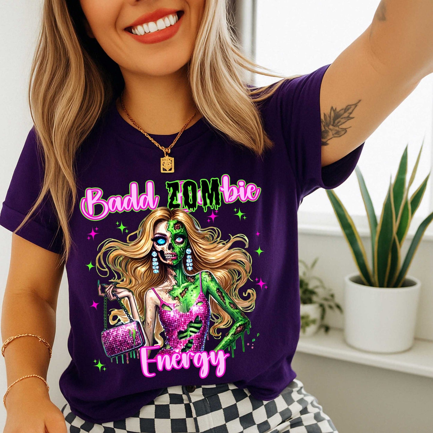 Brains, but make it fashion. This Badd Zombie Energy tee is for the girls who slay… even in the afterlife. Rocking a glittery pink dress, designer handbag, and enough undead glam to raise the dead, this zombie babe is dripping in sass (and maybe a little ooze).