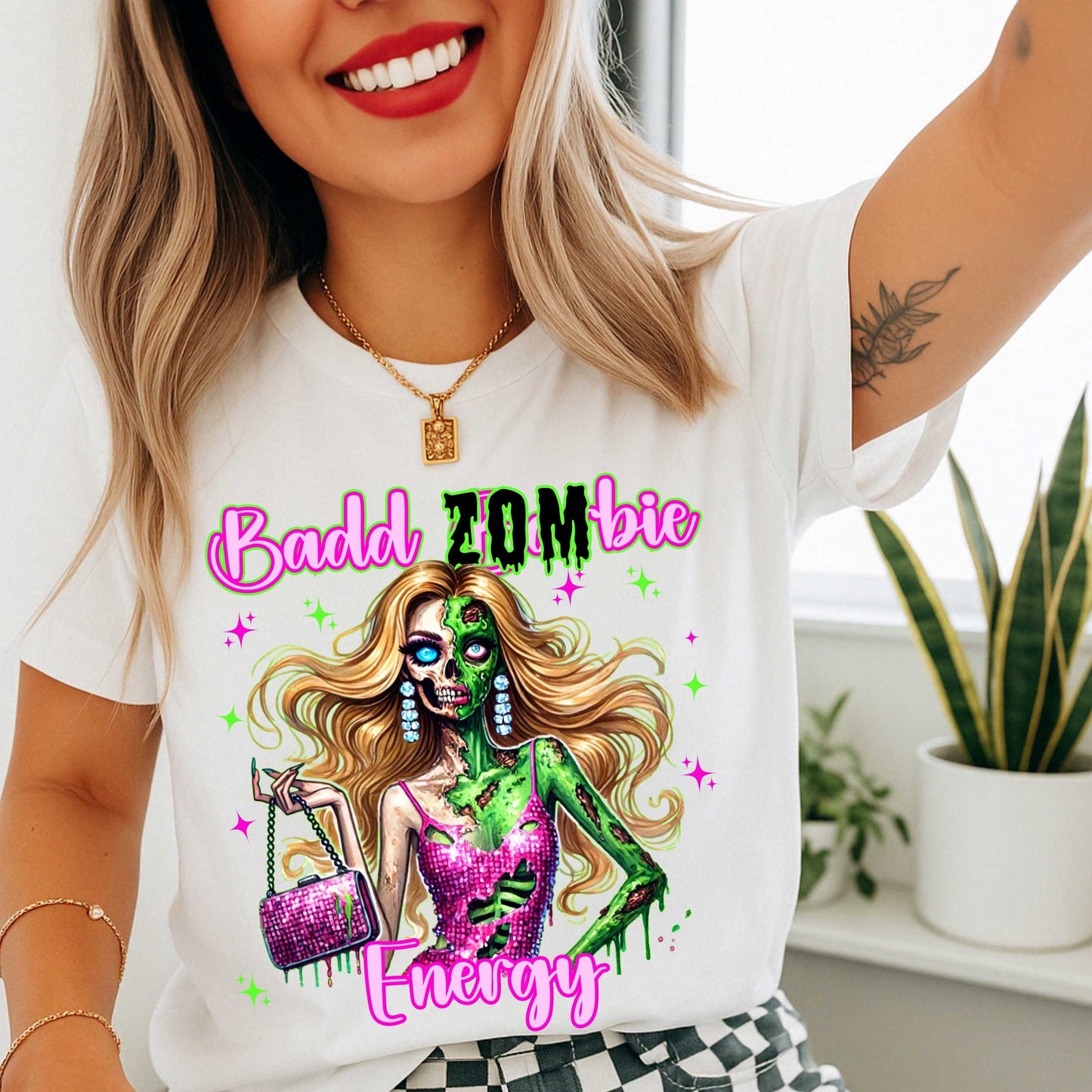 Brains, but make it fashion. This Badd Zombie Energy tee is for the girls who slay… even in the afterlife. Rocking a glittery pink dress, designer handbag, and enough undead glam to raise the dead, this zombie babe is dripping in sass (and maybe a little ooze).